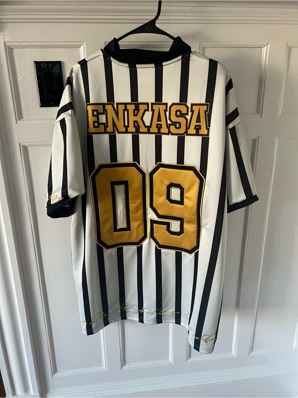 Black & White Striped Jersey with Gold '09' and ENKASA Backprint